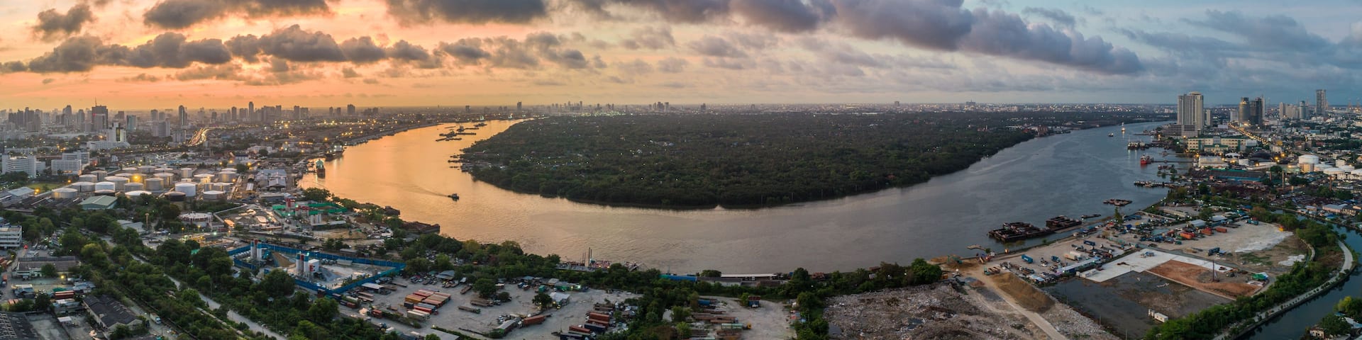 A river winding through a city with industrial areas and dense urban development.