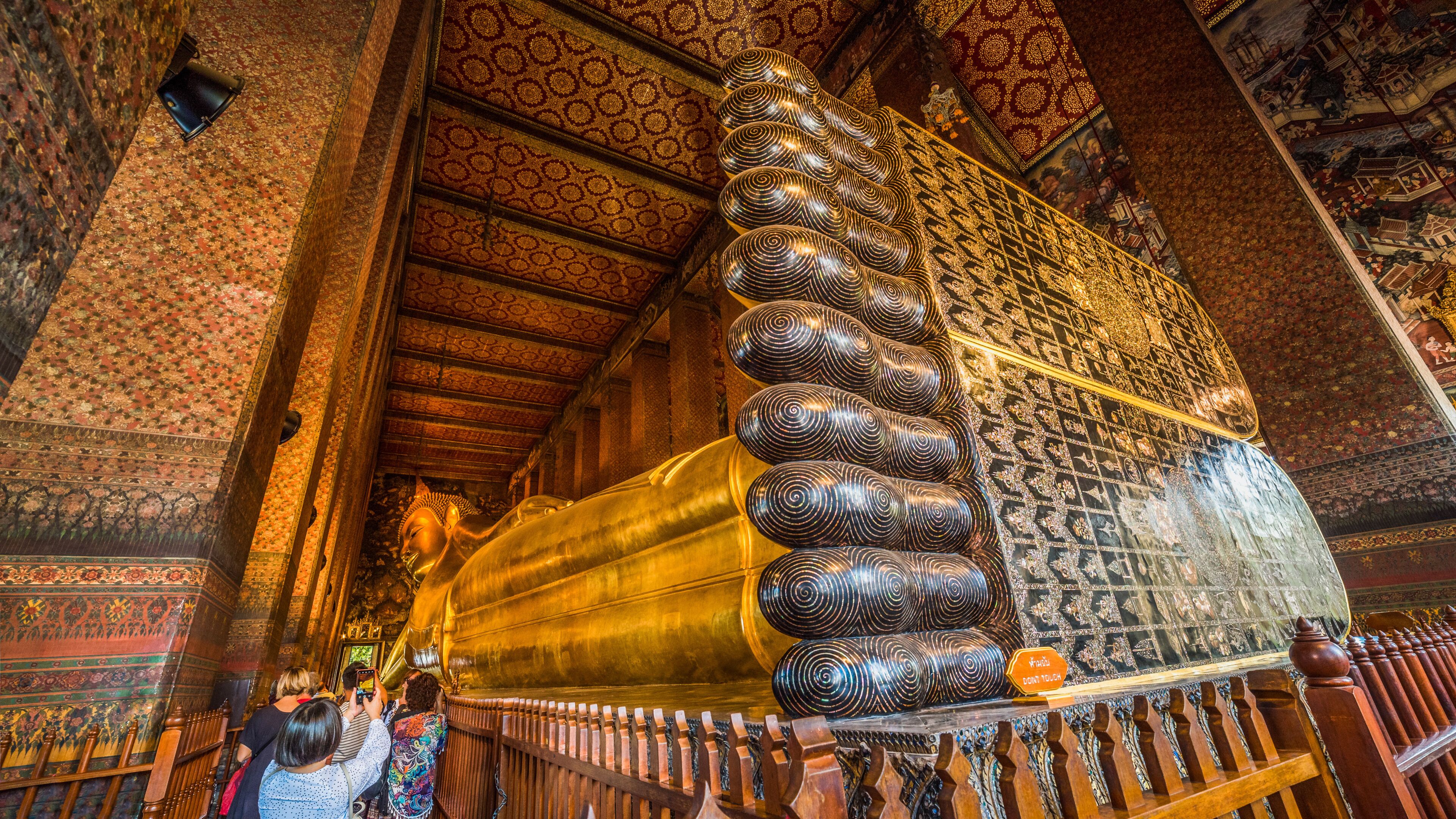 Golden Statue of the Reclining Buddha at Wat Pho Buddhist Temple Complex in the Phra Nakhon District, Bangkok, Thailand. Religious Monument, Tourist Attraction, Travel Destination Concepts.