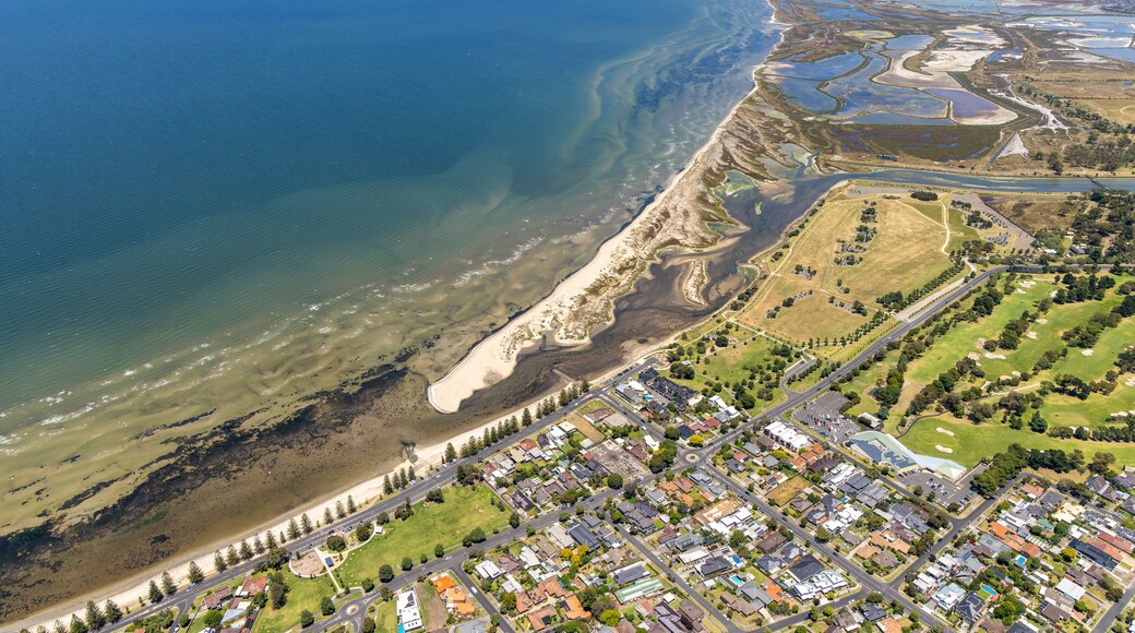 A coastal town with a beach, residential areas, and industrial zones.