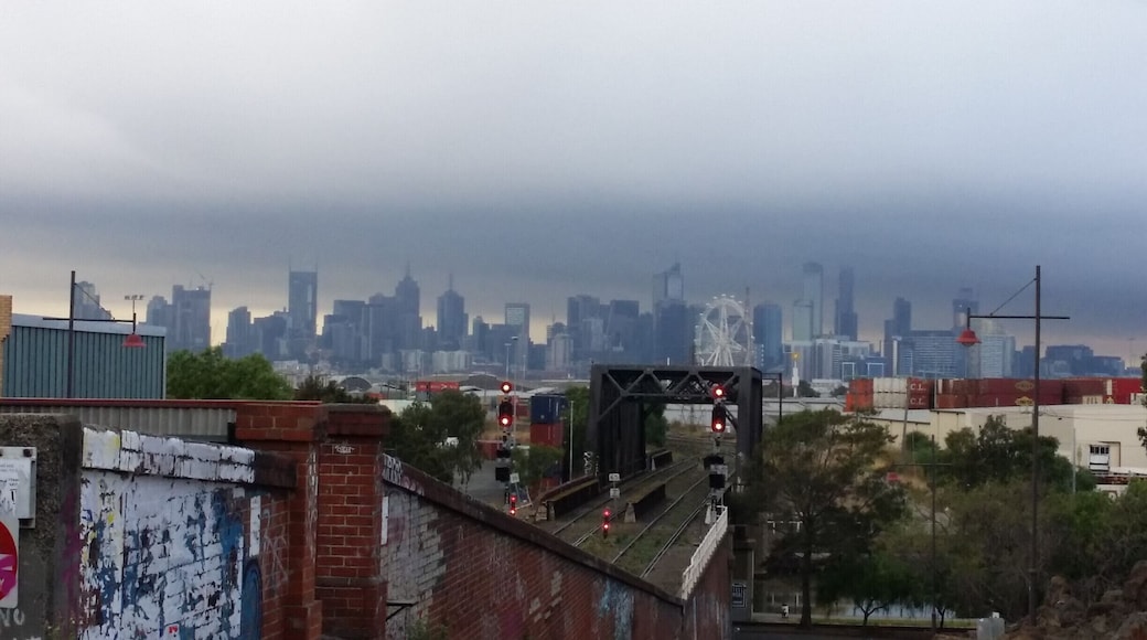 Looking east towards Melbourne CBD (city centre) from Footscray on a foggy autumn morning. The Melbourne Star observation wheel is straight ahead. To the right is part of the Port of Melburne.