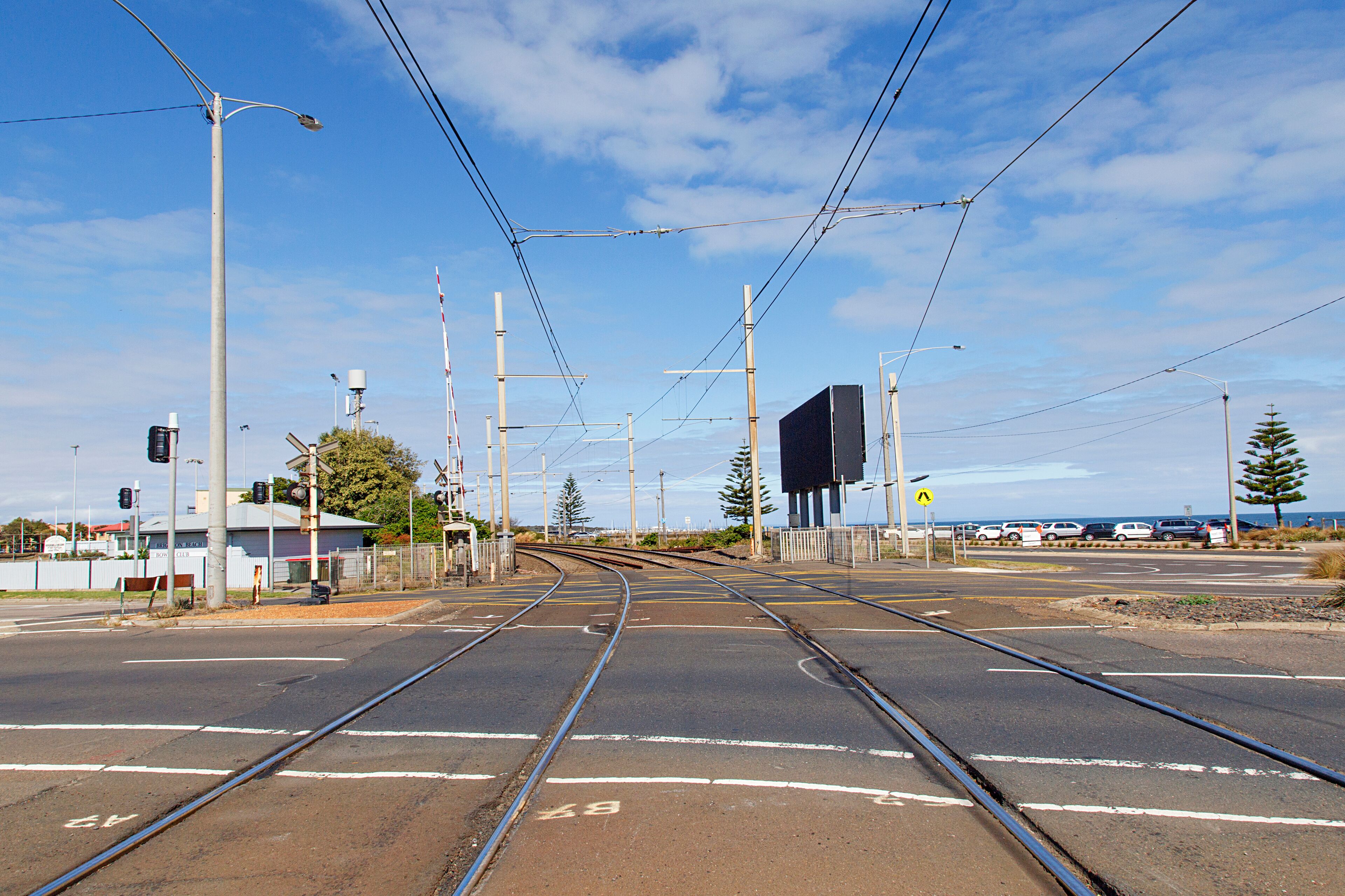 The level crossing over the main road at Brighton Beach Railway Station which is located on the Sandringham line in Victoria, Australia.