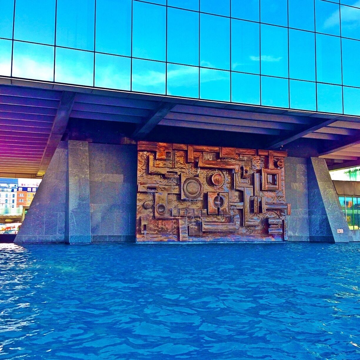 Most visible tower of Brussels just next to the main station, Gare du Midi ("Midi" referring to the southwards going trains towards the Mediterranean Sea. Spectacular glass tower on a seemingly tiny triangular base standing in water.