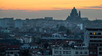 Brussels city center, Belgium - Yellow sunset over Molenbeek, Koekelberg and Ganshoren with the Basilica of the Sacred Heart in the background