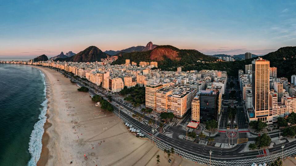 Aerial drone view of Copacabana Beach and urban setting at sunrise, UNESCO World Heritage Site, Rio de Janeiro, Brazil