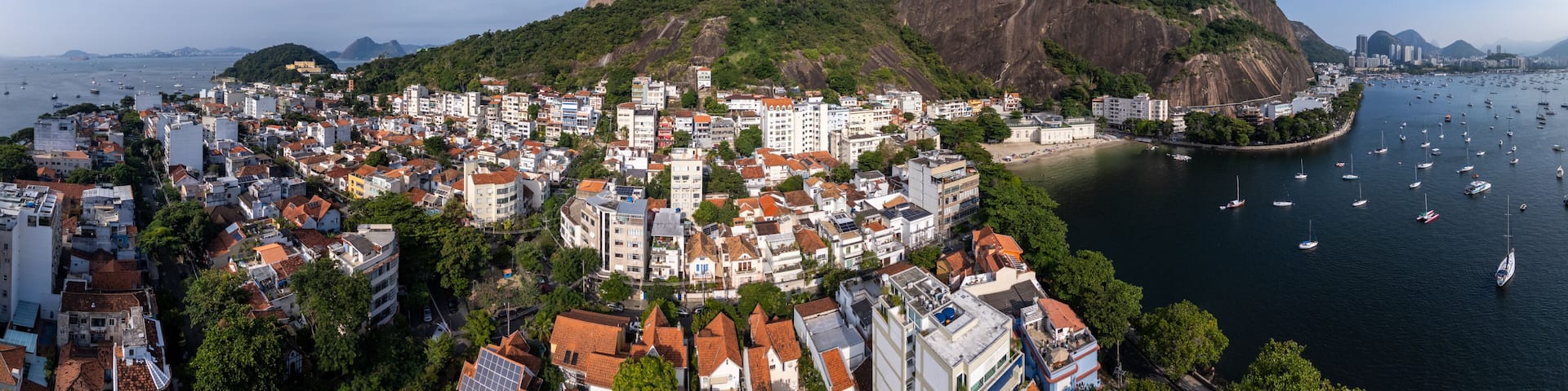 Aerial view of Sugarloaf Mountain and the Urca neighborhood with boats anchored in Guanabara Bay, Rio de Janeiro, State of Rio de Janeiro, Brazil.