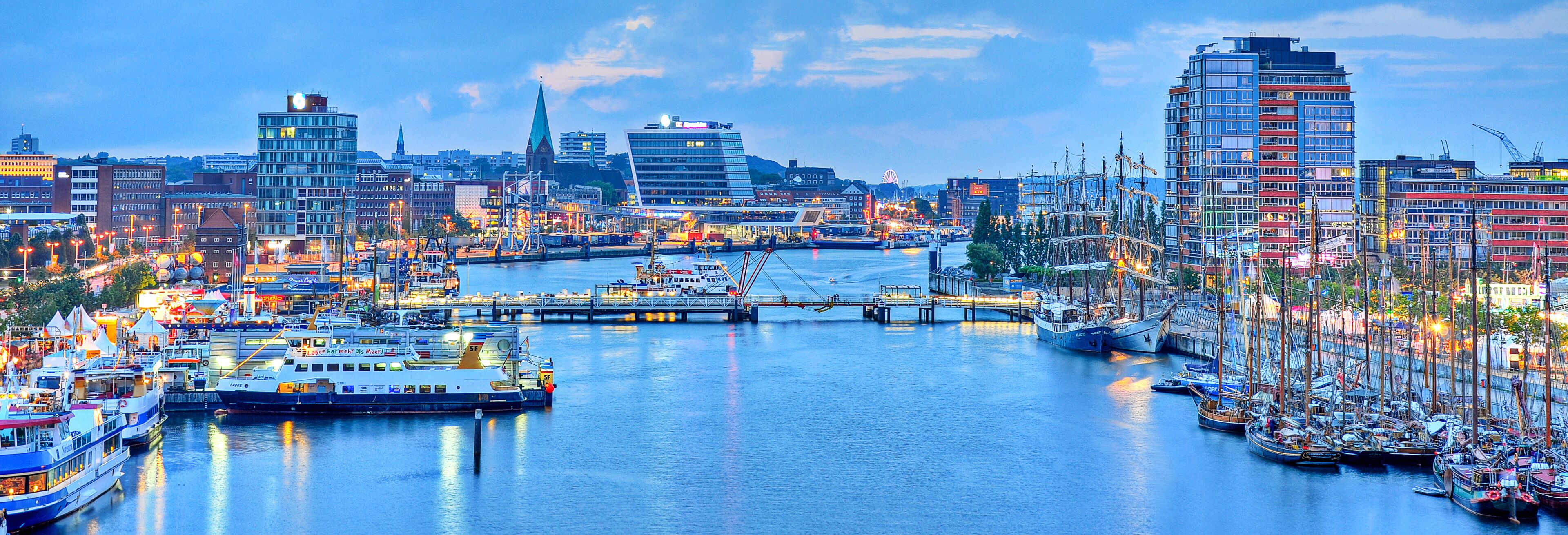 A harbor with boats, a bridge, and buildings.