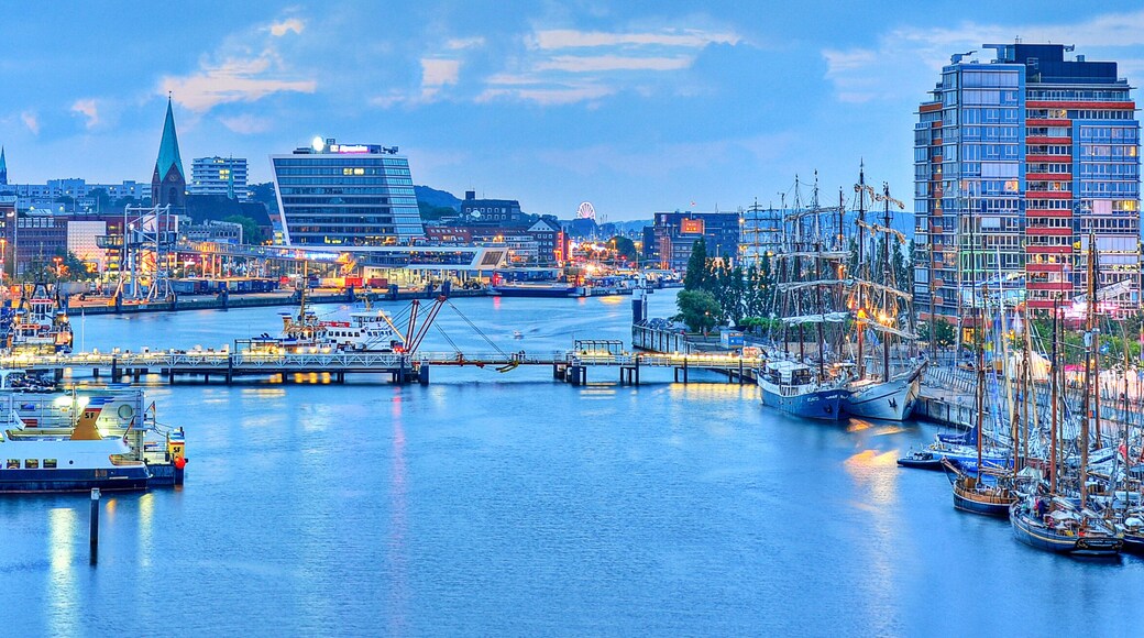 A harbor with boats, a bridge, and buildings.
