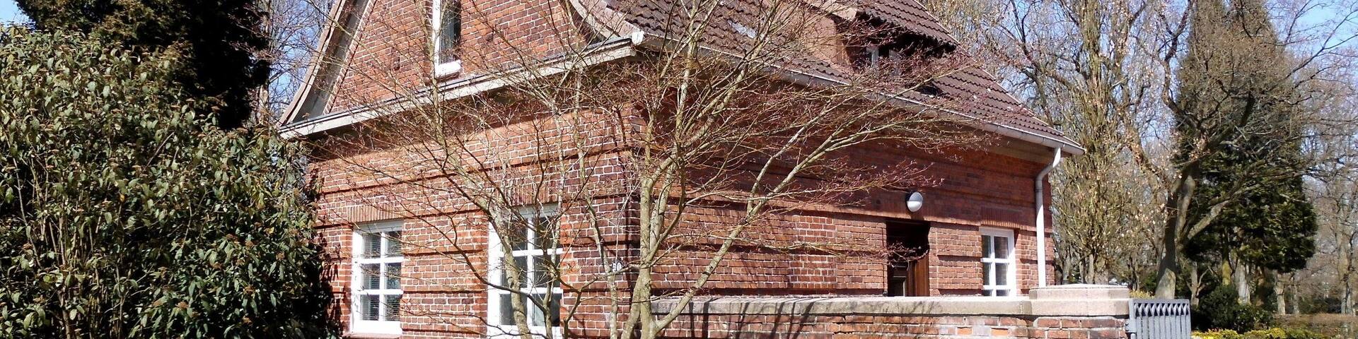 A brick house with a sloped roof and a small porch.