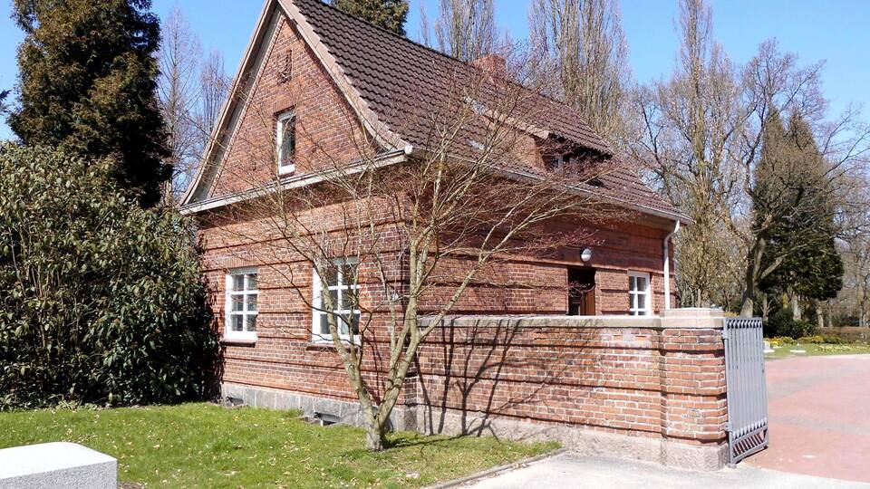 A brick house with a sloped roof and a small porch.