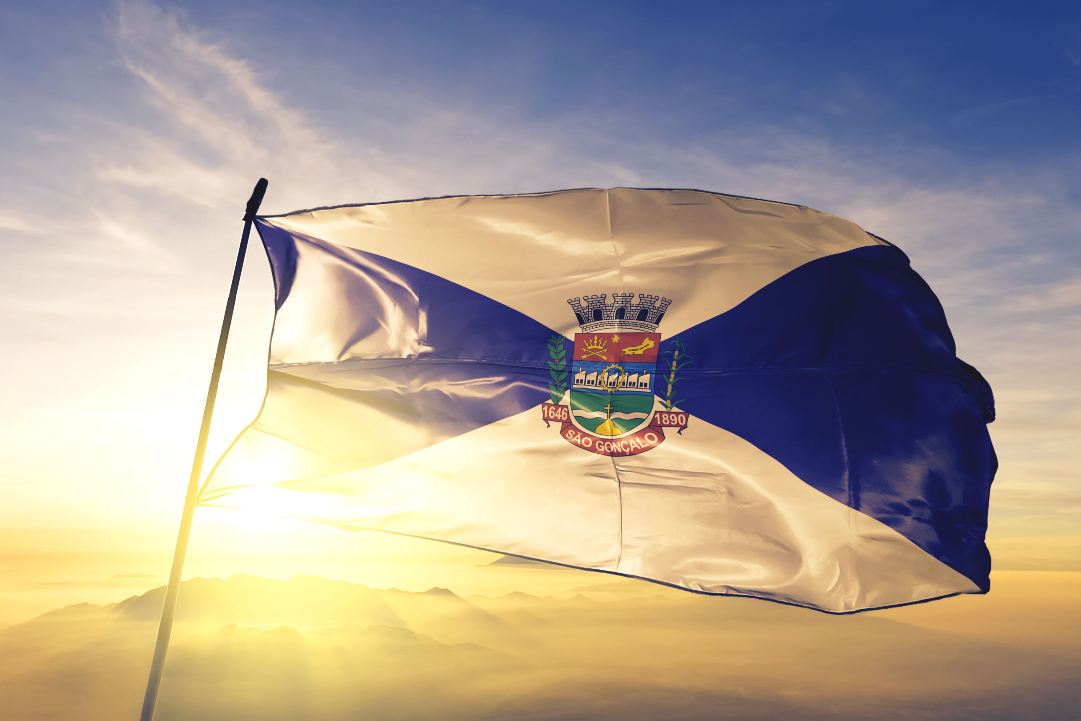 Sao Goncalo of Brazil flag waving on the top sunrise mist fog
