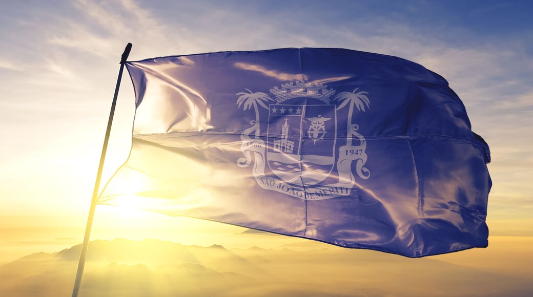 Sao Joao de Meriti of Brazil flag waving on the top sunrise mist fog