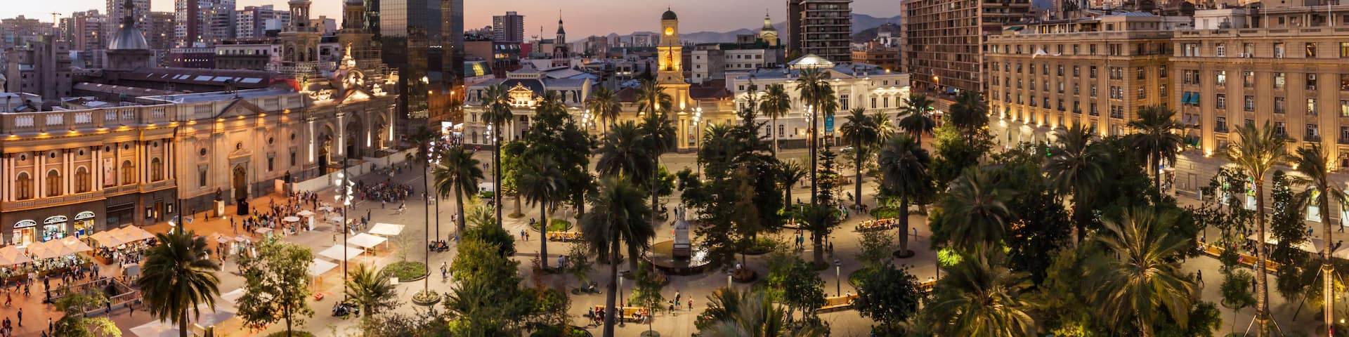 A cityscape with a prominent historical building, palm trees, and modern high-rise buildings.
