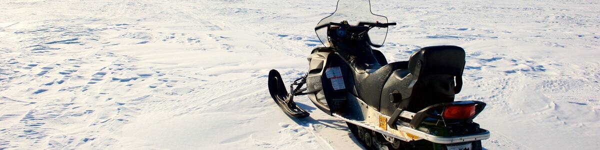 A snowmobile on a snowy landscape.