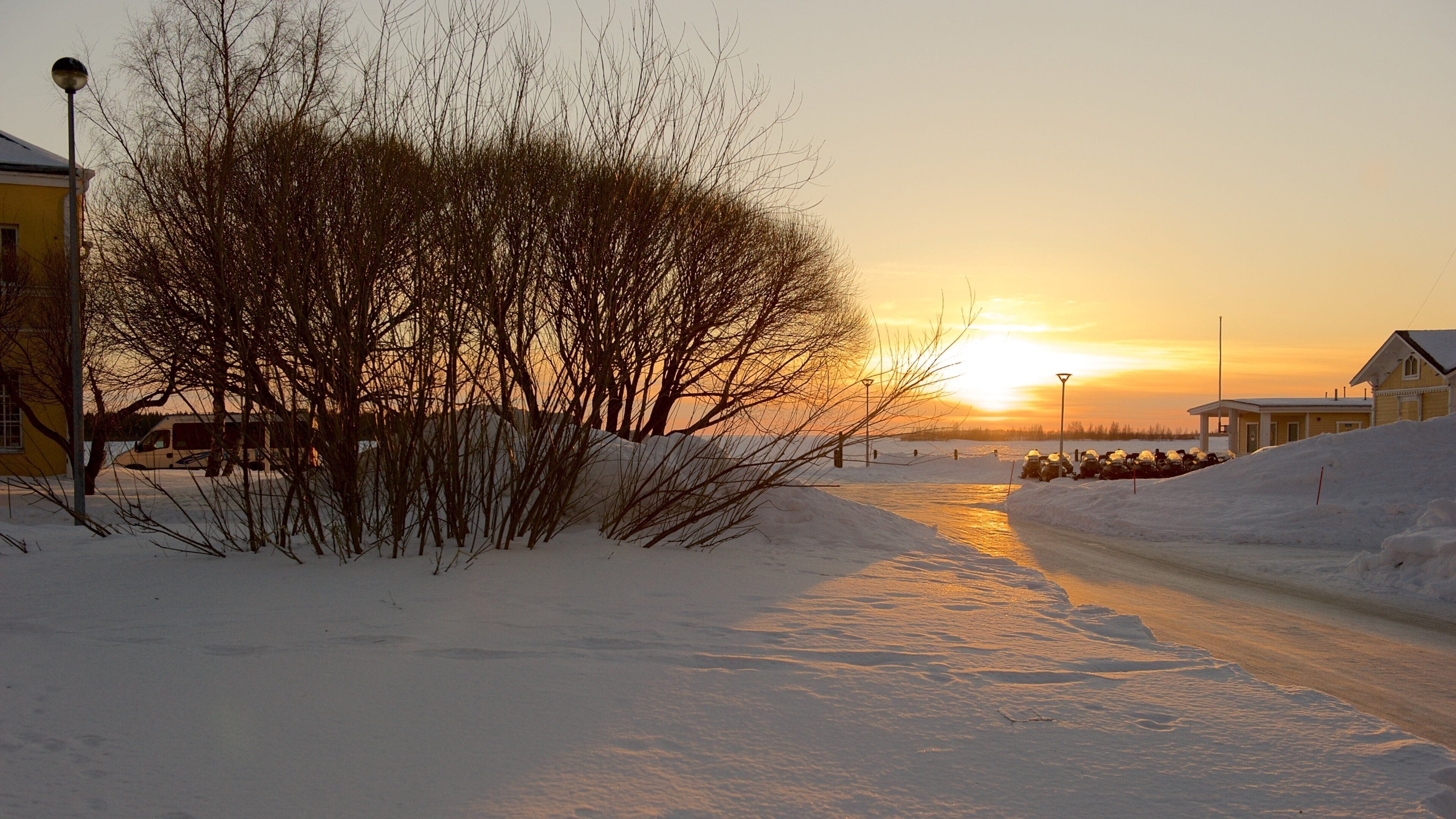 Kemi showing a small town or village, a sunset and snow