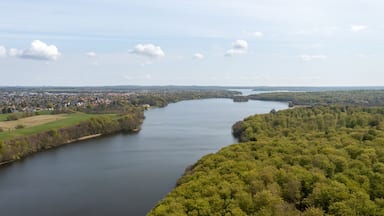 A river winding through a town surrounded by dense forests.