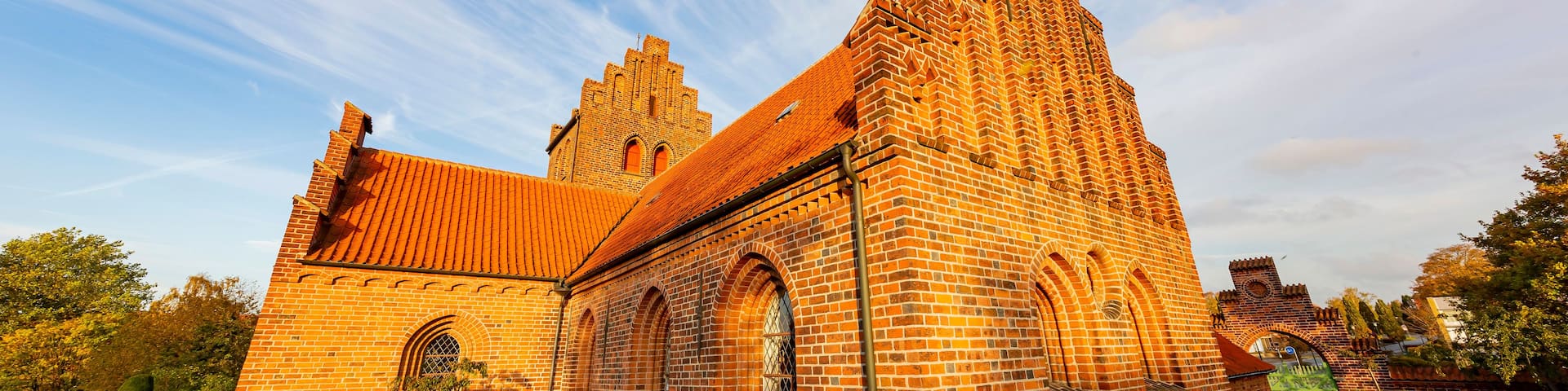A historic church with a prominent tower and arched windows.
