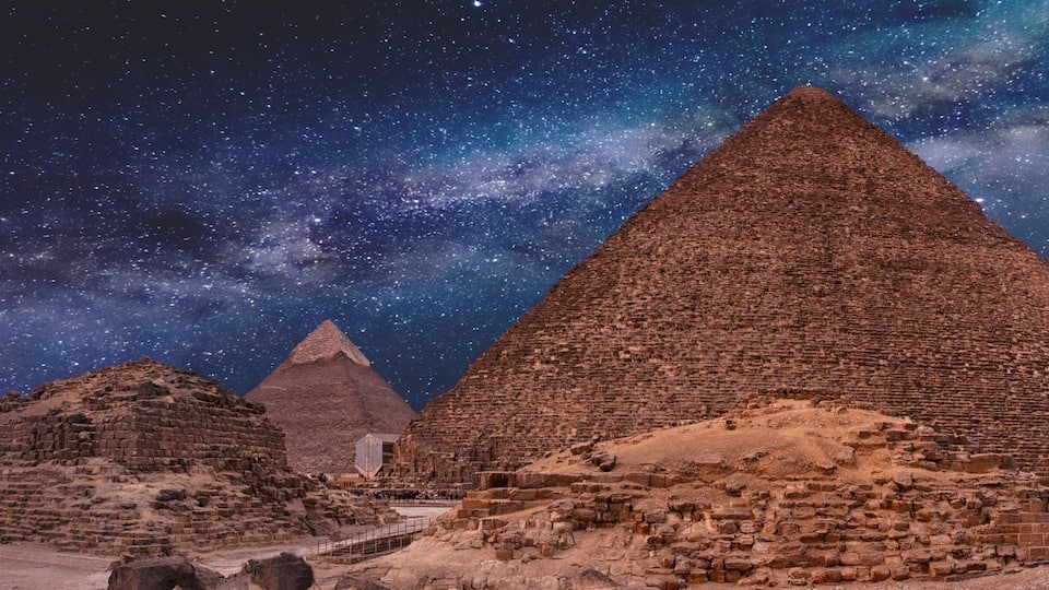 Night sky of the Milky Way over the great pyramids on the plateau of Giza, Egypt, Africa.