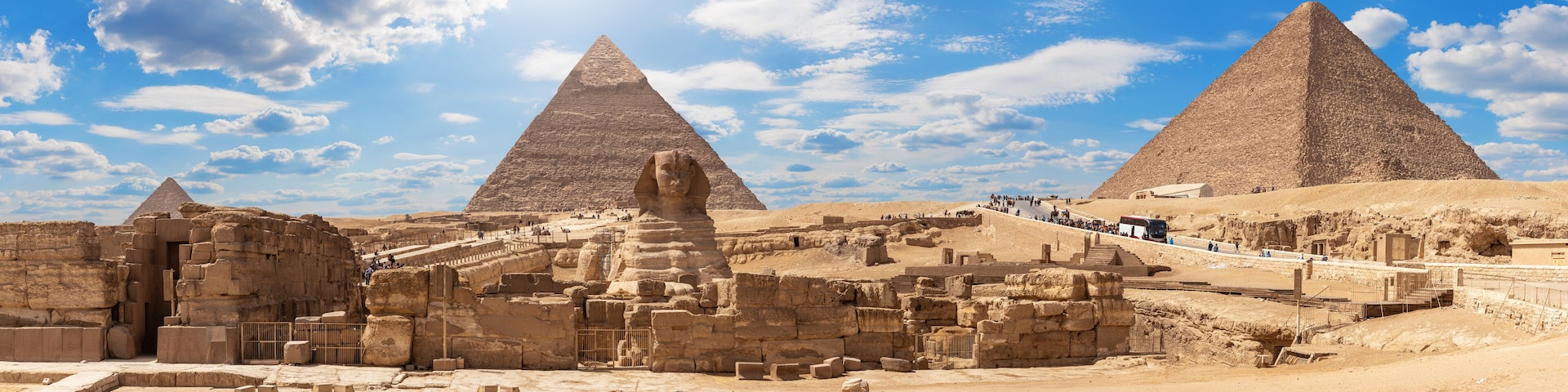 The Great Pyramid of Giza, the Sphinx, and ancient ruins.
