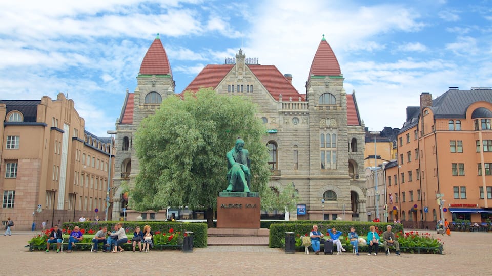 Kluuvi featuring heritage architecture and a statue or sculpture as well as a small group of people