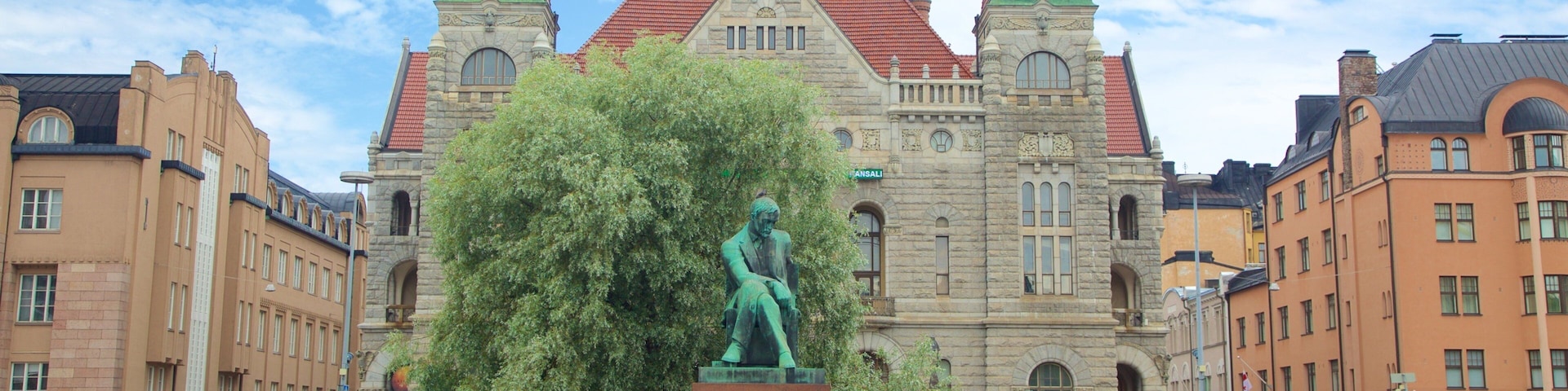 Kluuvi featuring heritage architecture and a statue or sculpture as well as a small group of people