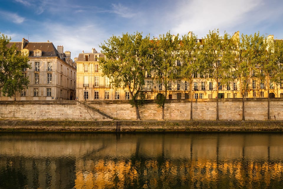 A river with buildings and trees along the banks.
