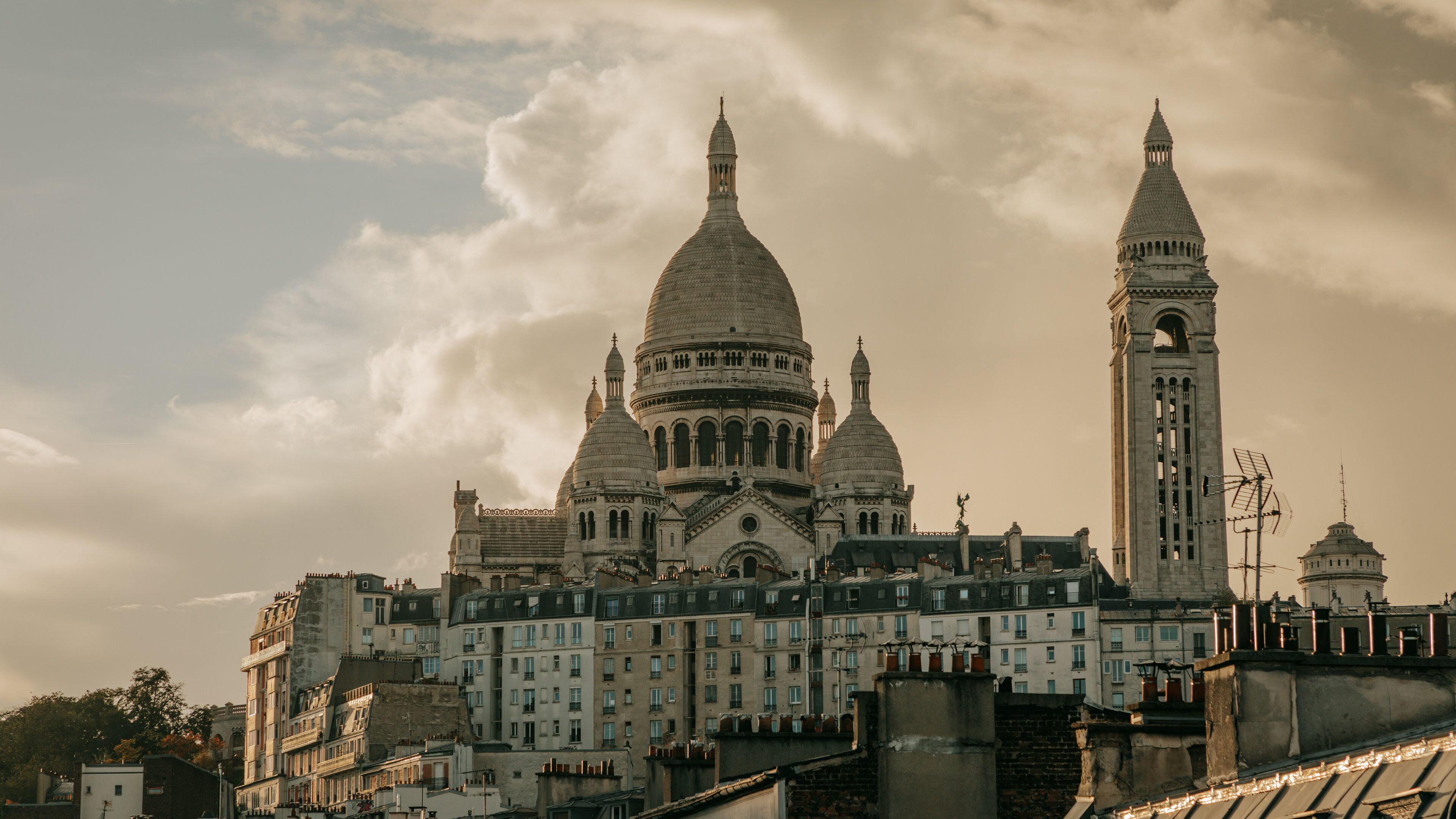 A historic cathedral with multiple domes and a tall clock tower.