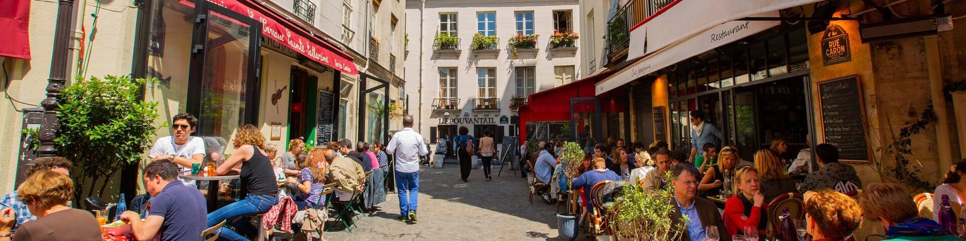 A bustling European street with cafes and restaurants.
