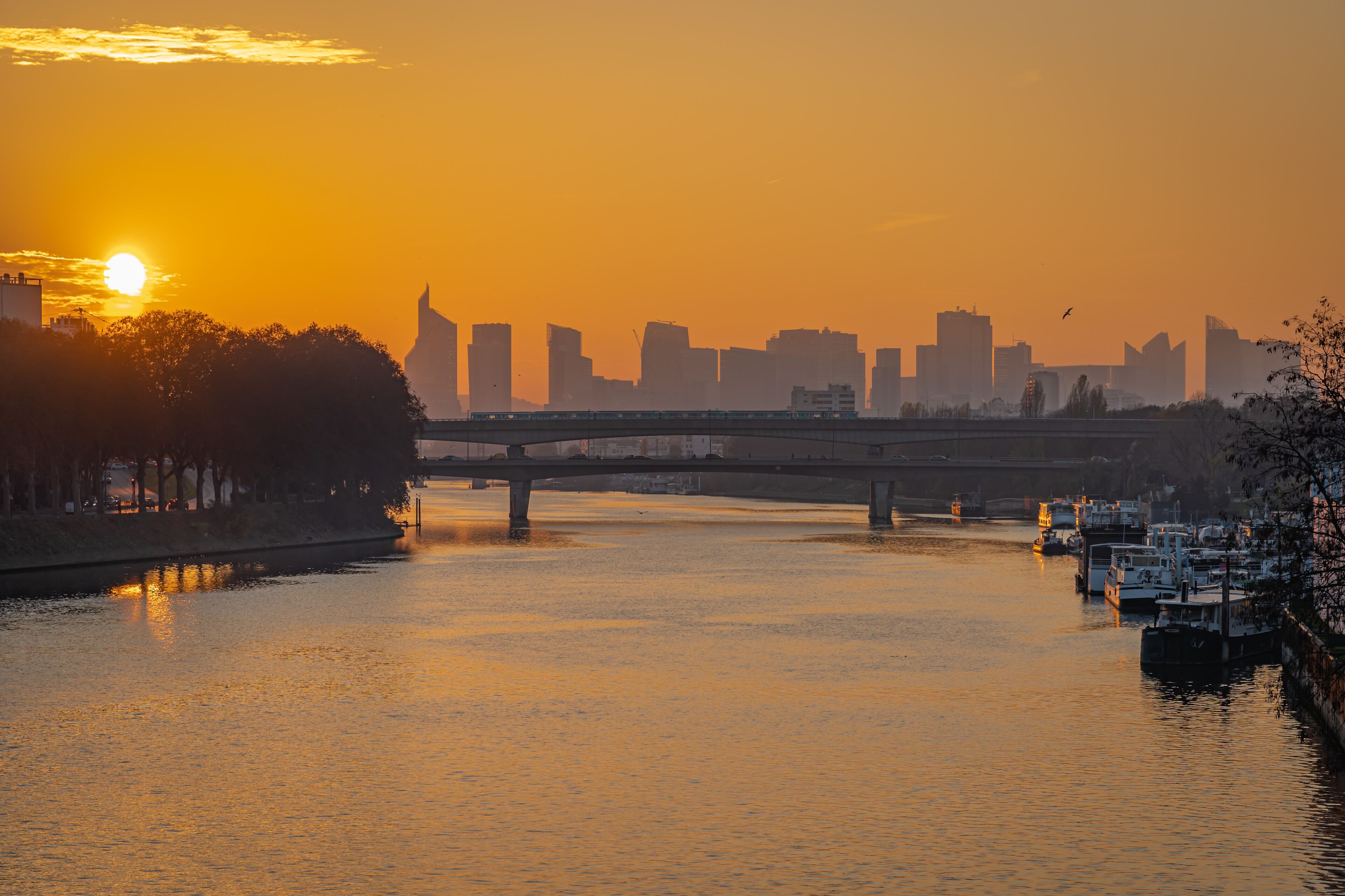 Gennevilliers, France - 27 11 2020: View of the Seine and The Defense district at sunset from Clichy Bridge