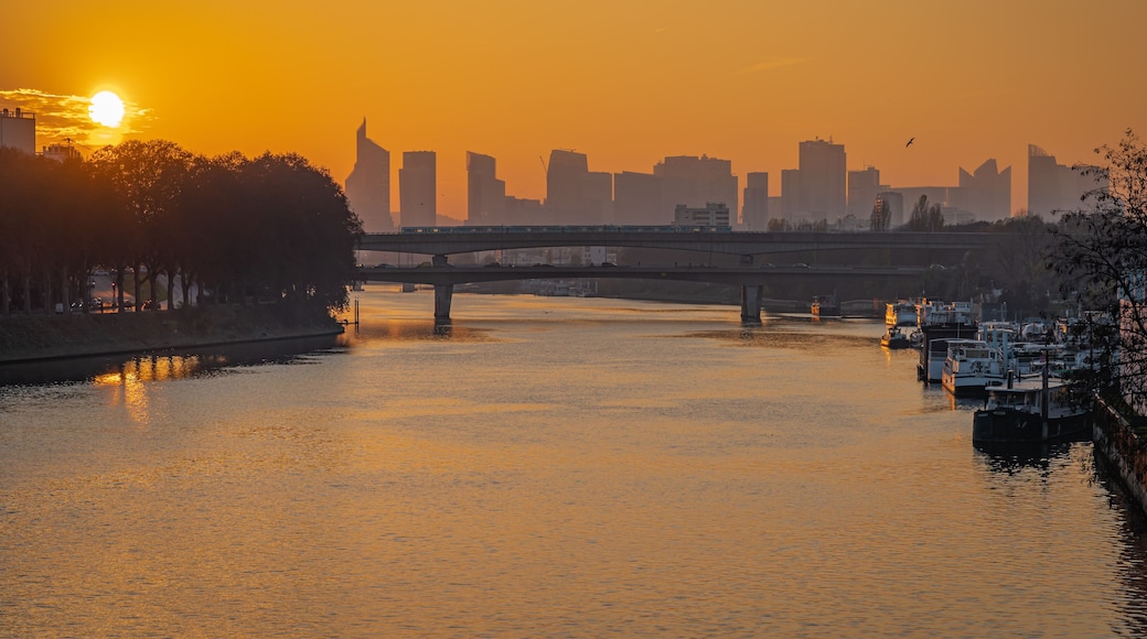 Gennevilliers, France - 27 11 2020: View of the Seine and The Defense district at sunset from Clichy Bridge