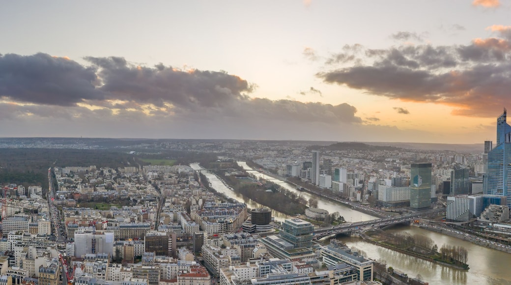 Panoramic aerial drone shot of Neuilly and la defense skyscraper complex in financial cbd area near la seine during sunset hour in Paris