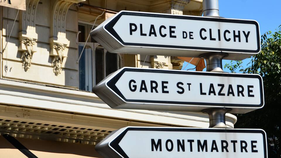 Street signs for Place de Clichy, Gare St Lazare, and Montmartre.