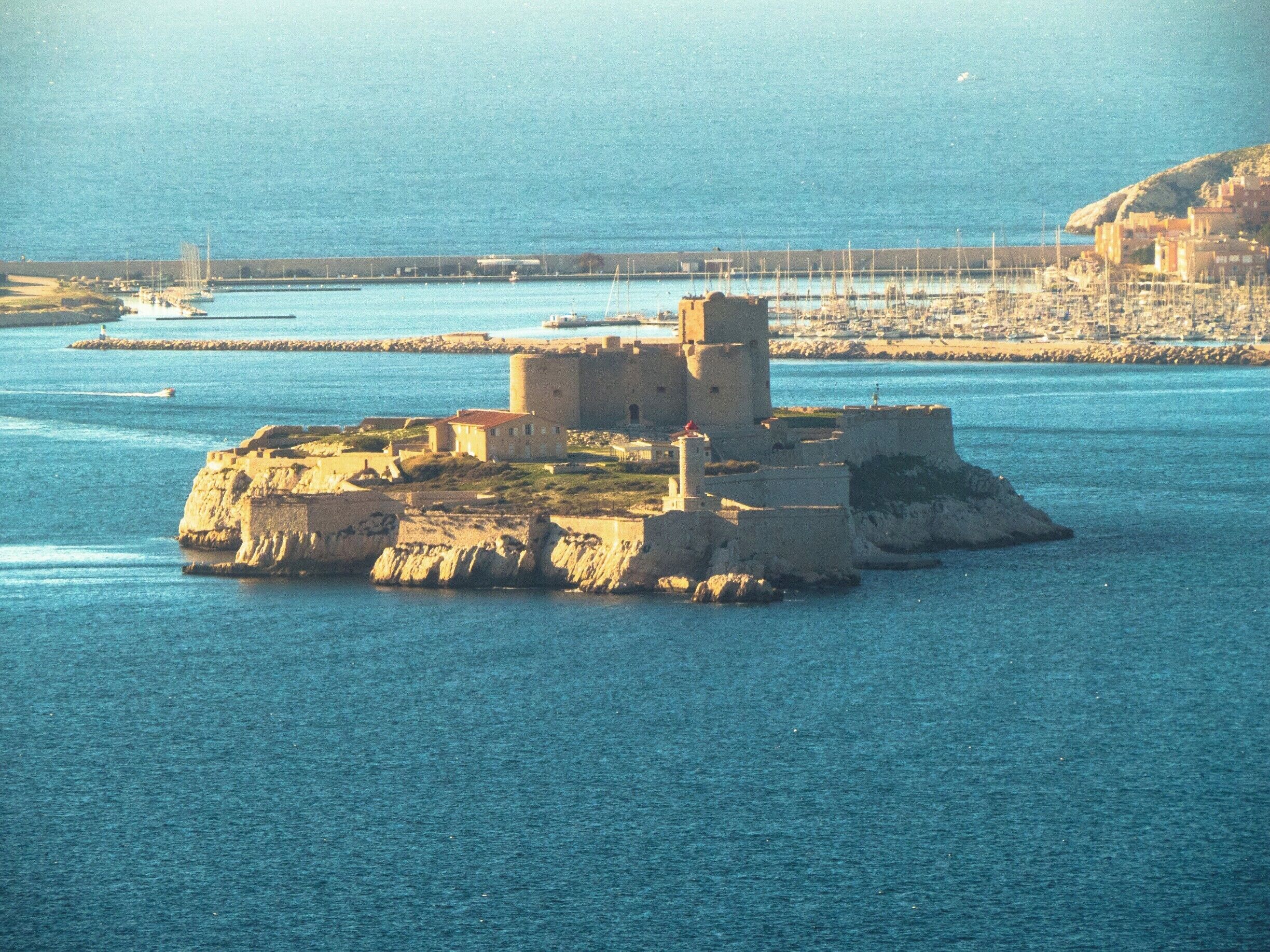 A coastal fortress on a small island surrounded by water.