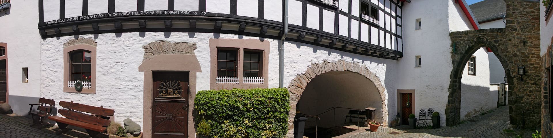 A half-timbered residential house and a city gate in the old town of Kronenburg, Eifel region in Germany