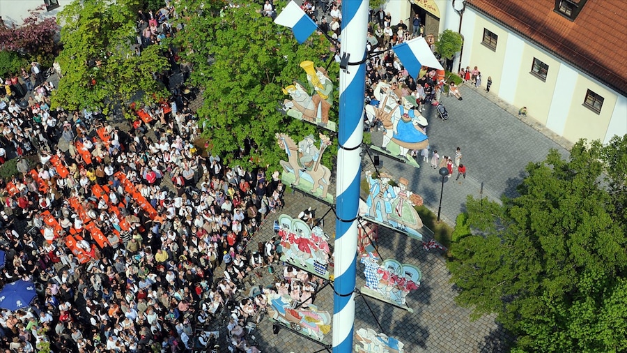 Ismaning which includes a square or plaza and a small town or village as well as a large group of people