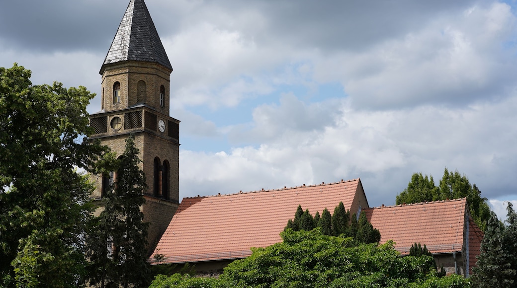 A church with a tall steeple and a clock tower.