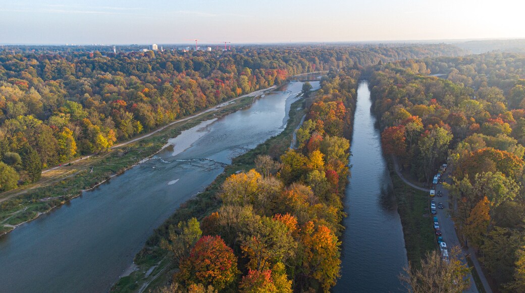Aerial views of autumn in Munich. Isar river seen from above with colorful trees nearby