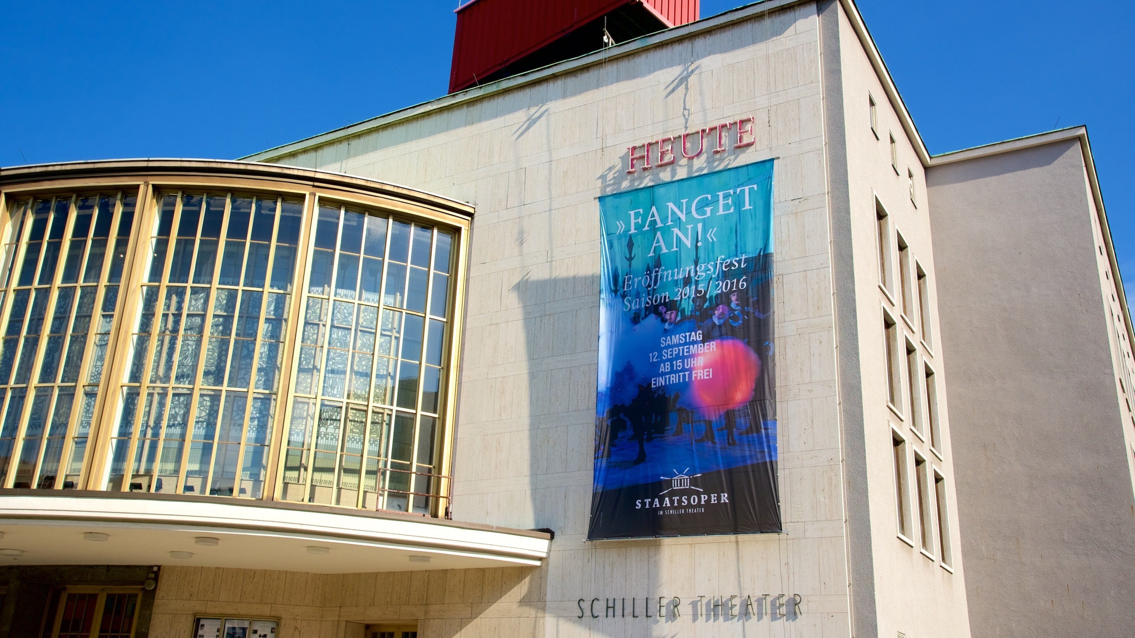 A building with a large poster advertising a festival.