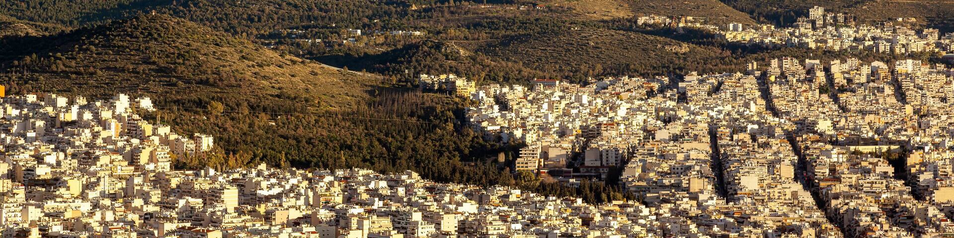 Majestic sunset with marvellous clouds over Hymettus mount and Athens city, Greece. There are several districts included like Ilioupoli, Kesariani, Vyronas and Kareas.