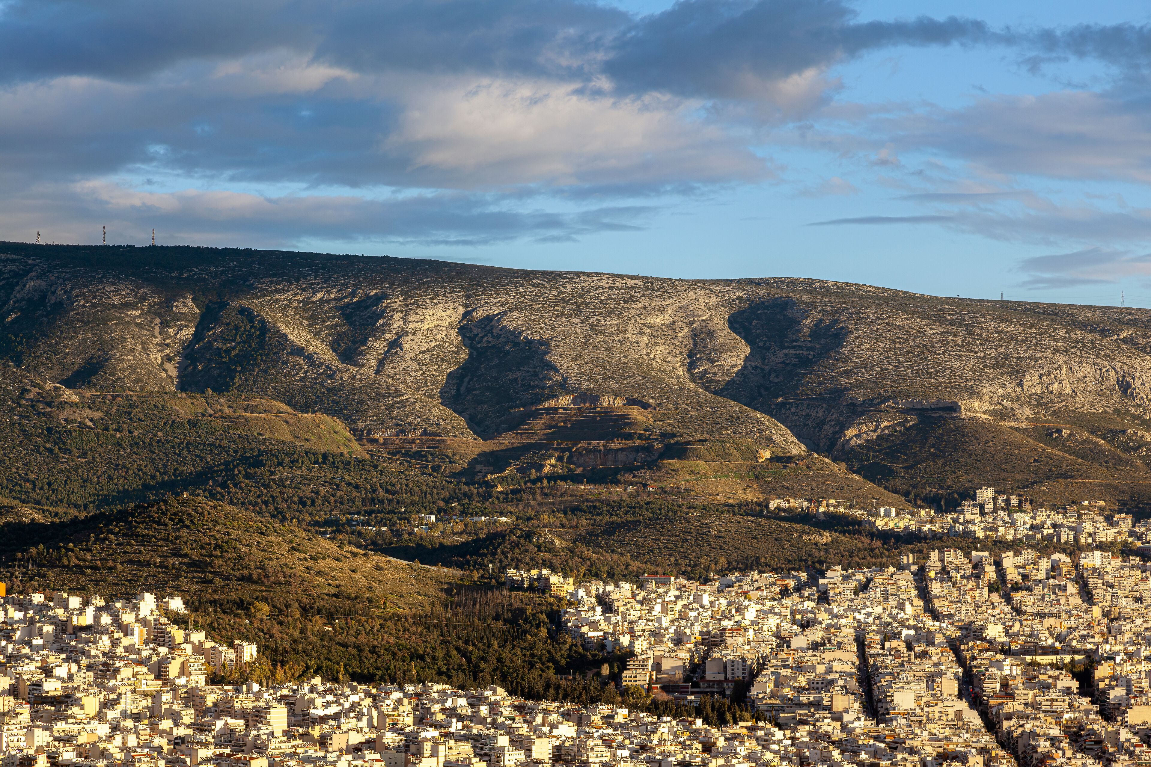 A cityscape with a mountainous backdrop.