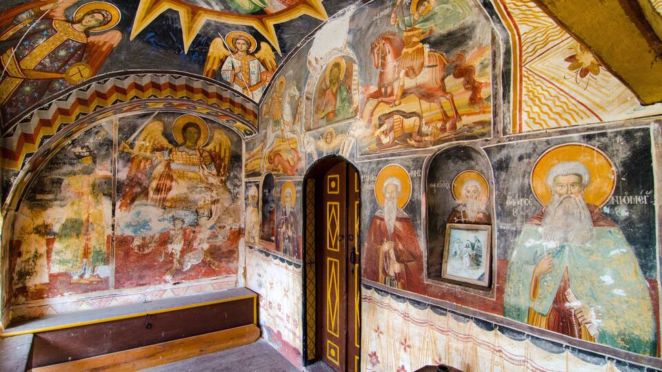 A church interior with religious frescoes and icons.