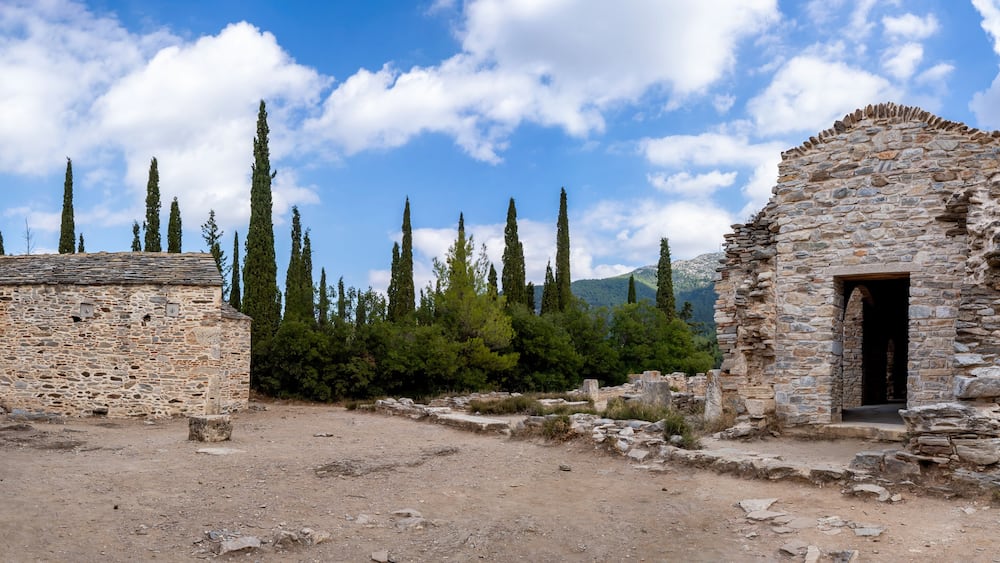 Ayios Marcos temple or Fragomonastiro on the right, Taxiarches temple on the left, located at the archaeological site of Taxiarches Hill in Kaisariani district, Athens, Greece, panoramic view, clouds