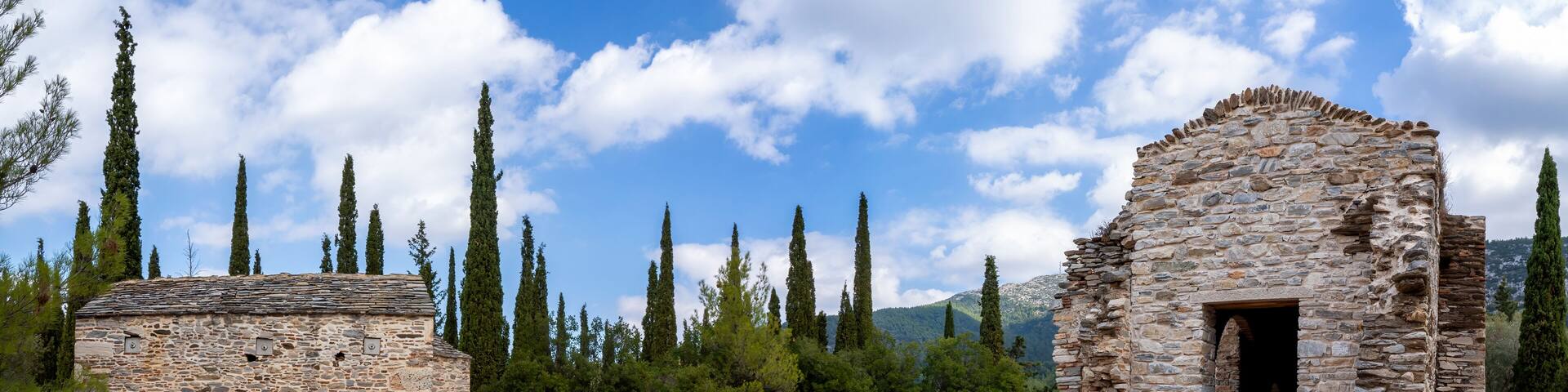 Ayios Marcos temple or Fragomonastiro on the right, Taxiarches temple on the left, located at the archaeological site of Taxiarches Hill in Kaisariani district, Athens, Greece, panoramic view, clouds