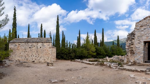 Ayios Marcos temple or Fragomonastiro on the right, Taxiarches temple on the left, located at the archaeological site of Taxiarches Hill in Kaisariani district, Athens, Greece, panoramic view, clouds
