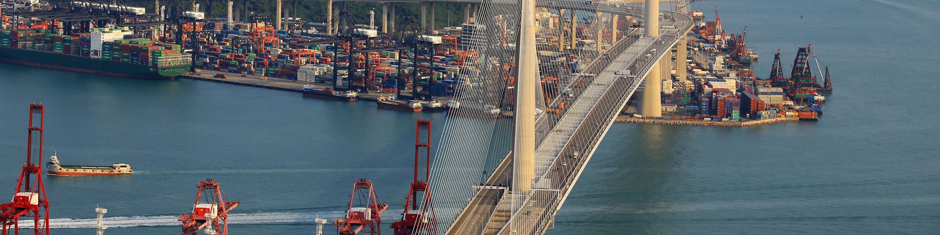 Kwai Tsing container terminal port view in drone, and hong kong skyline and stonecutter's bridge