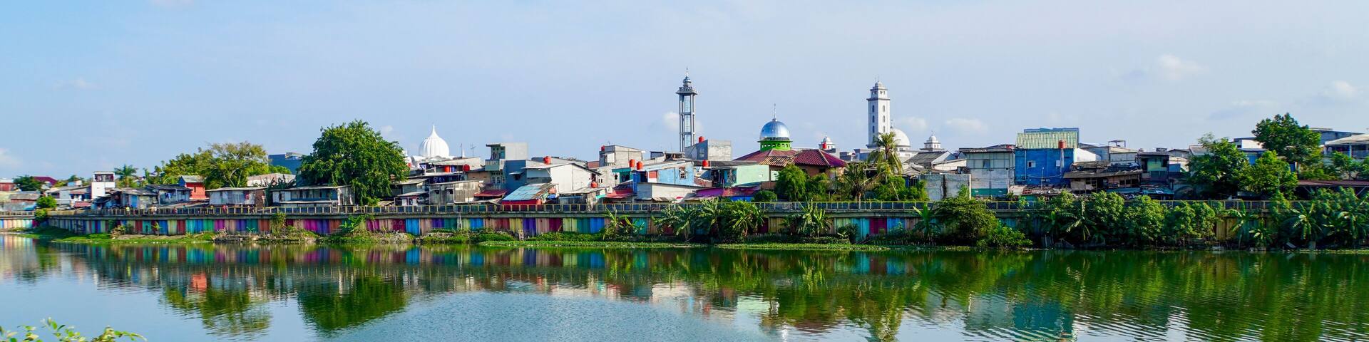 The calm waters at Sunter Lake in Jakarta, Indonesia, reflect the vast blue sky above