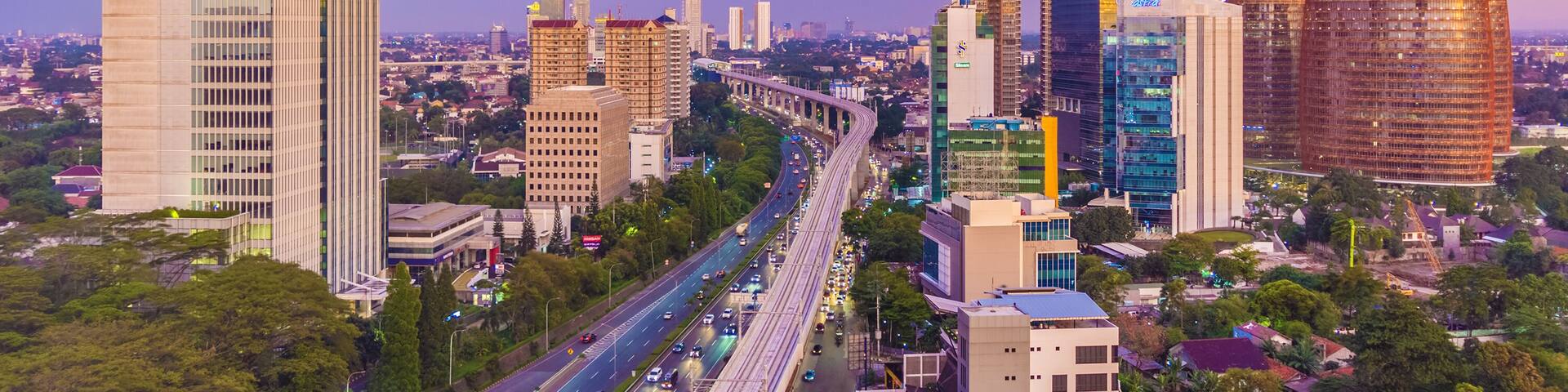 Jakarta, Indonesia - 30th December 2018: South Jakarta Cityscape at sunset, with beautiful pastel colored sky. Rail track construction is visible in the foreground.