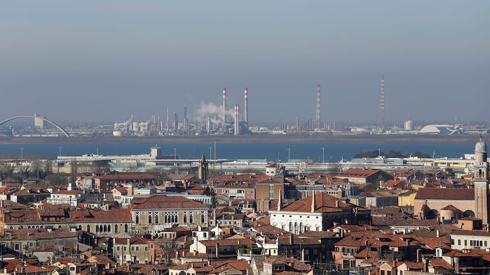 smokestacks and factories polluting with smoke near Venice