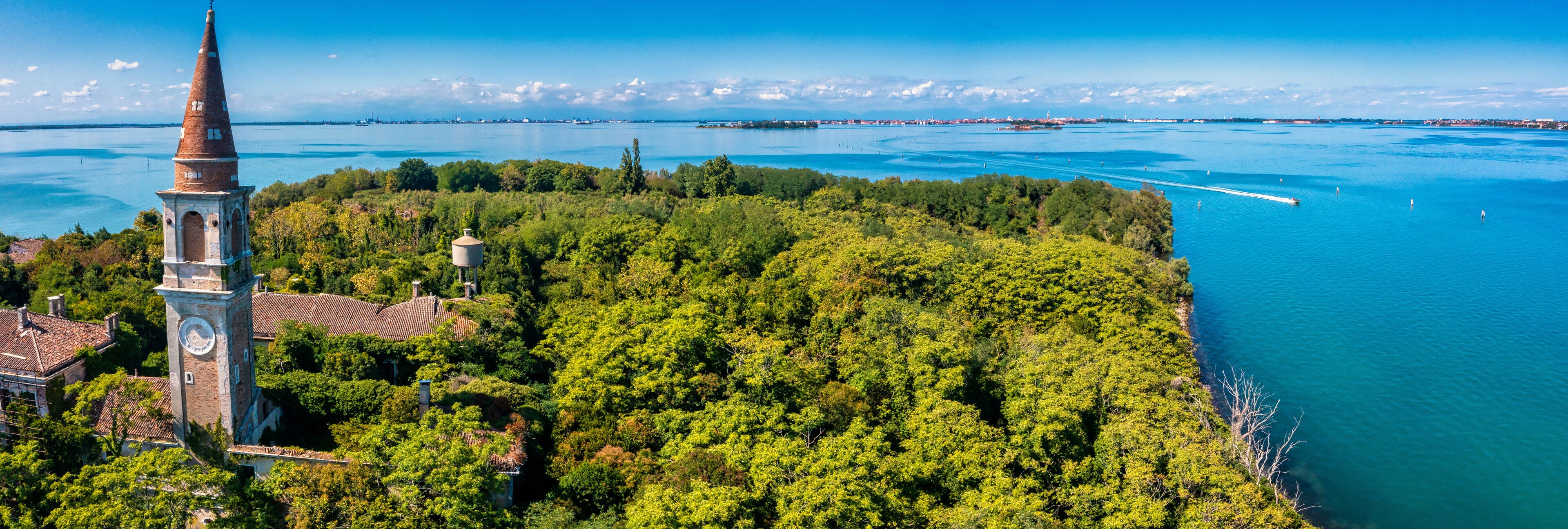 Aerial view of the plagued ghost island of Poveglia in the Venetian lagoon, opposite Malamocco along the Canal Orfano near Venice, Italy.