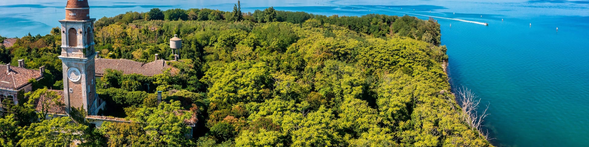 Aerial view of the plagued ghost island of Poveglia in the Venetian lagoon, opposite Malamocco along the Canal Orfano near Venice, Italy.