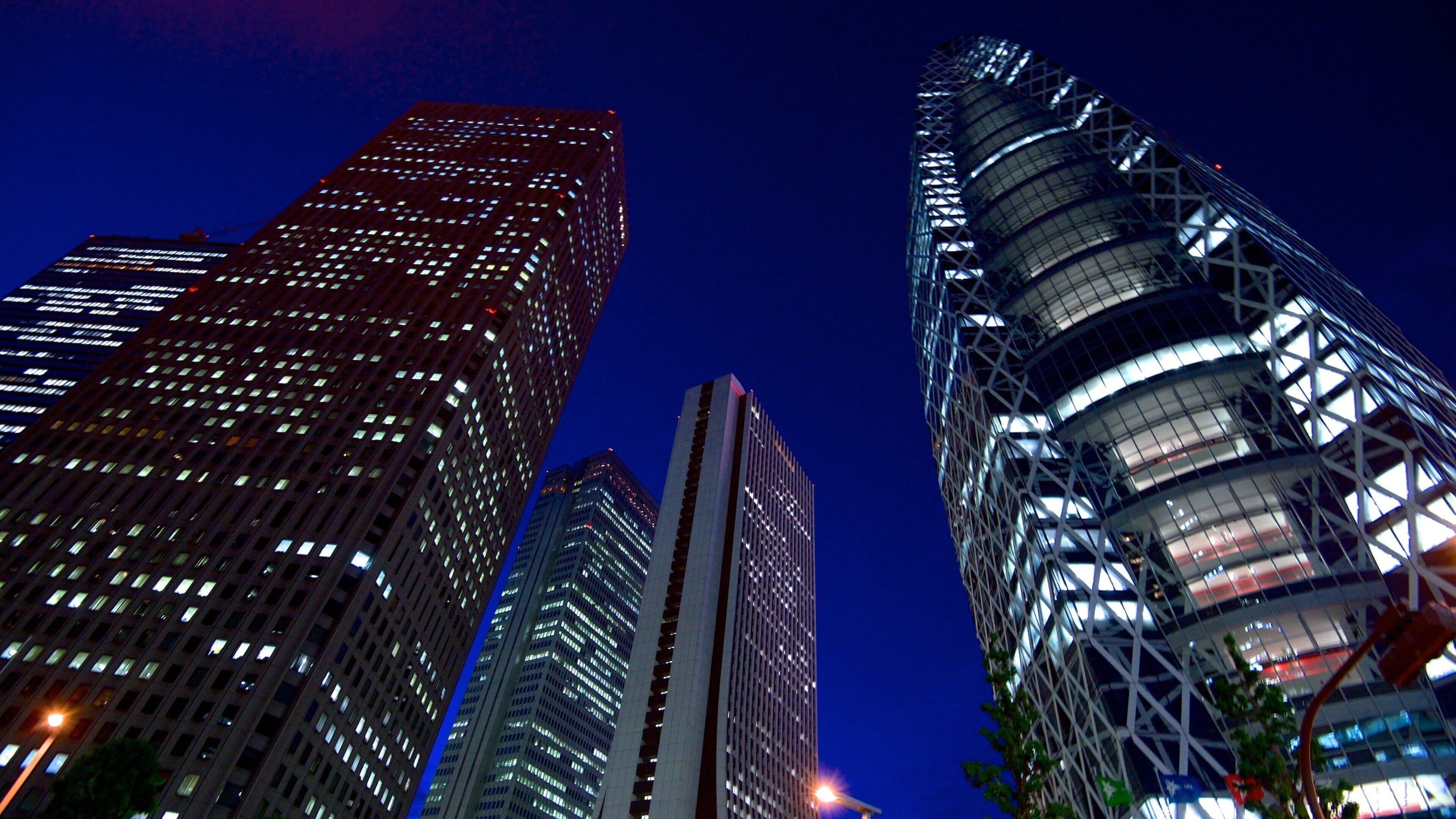 A cityscape at night with illuminated skyscrapers.